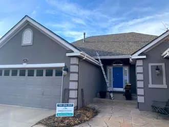A house with a blue door and a sign in front of it