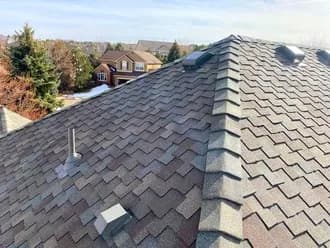 A close up of a roof with a lot of shingles on it.